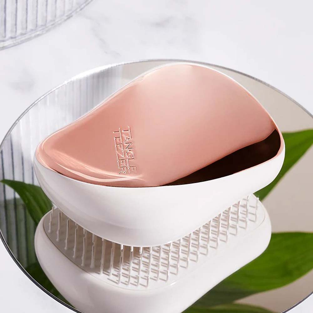 Close-up of Tangle Teezer Compact Styler showing two-tiered flexible teeth and sleek design.