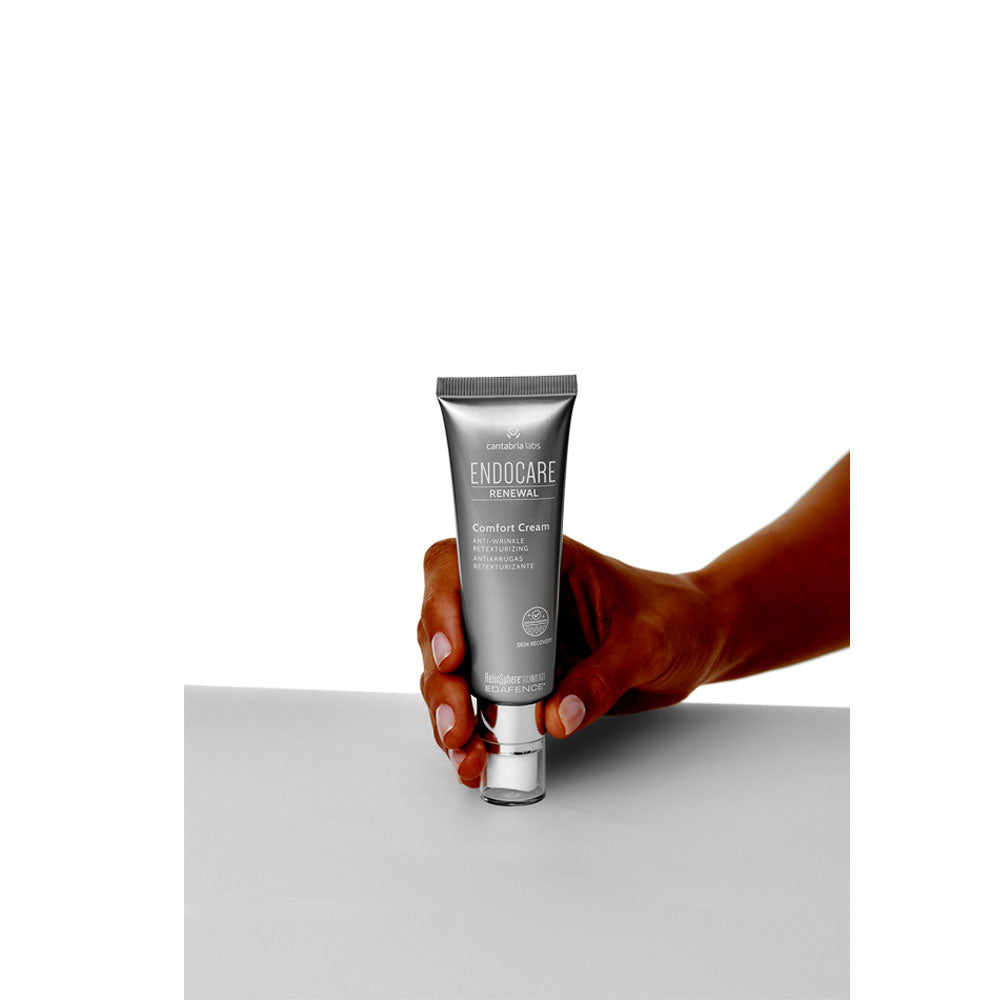 Endocare Renewal Comfort Cream 50ml tube held in hand, soothing anti-aging formula for sensitive skin.