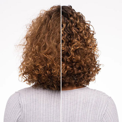 Model with shiny, defined curls after using Tangle Teezer Naturally Curly Detangler, showing smooth, tangle-free hair.