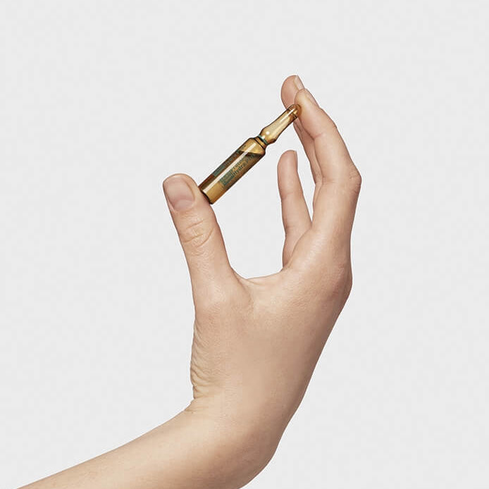 Hydrating anti-aging ampoules with Vitamin C in hand